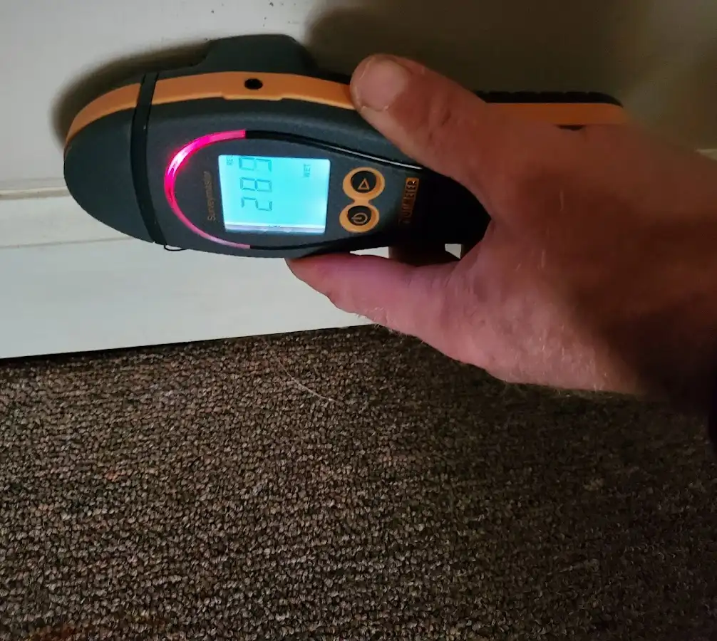 Moisture detection at baseboard during Storm Damage Restoration in Miramar